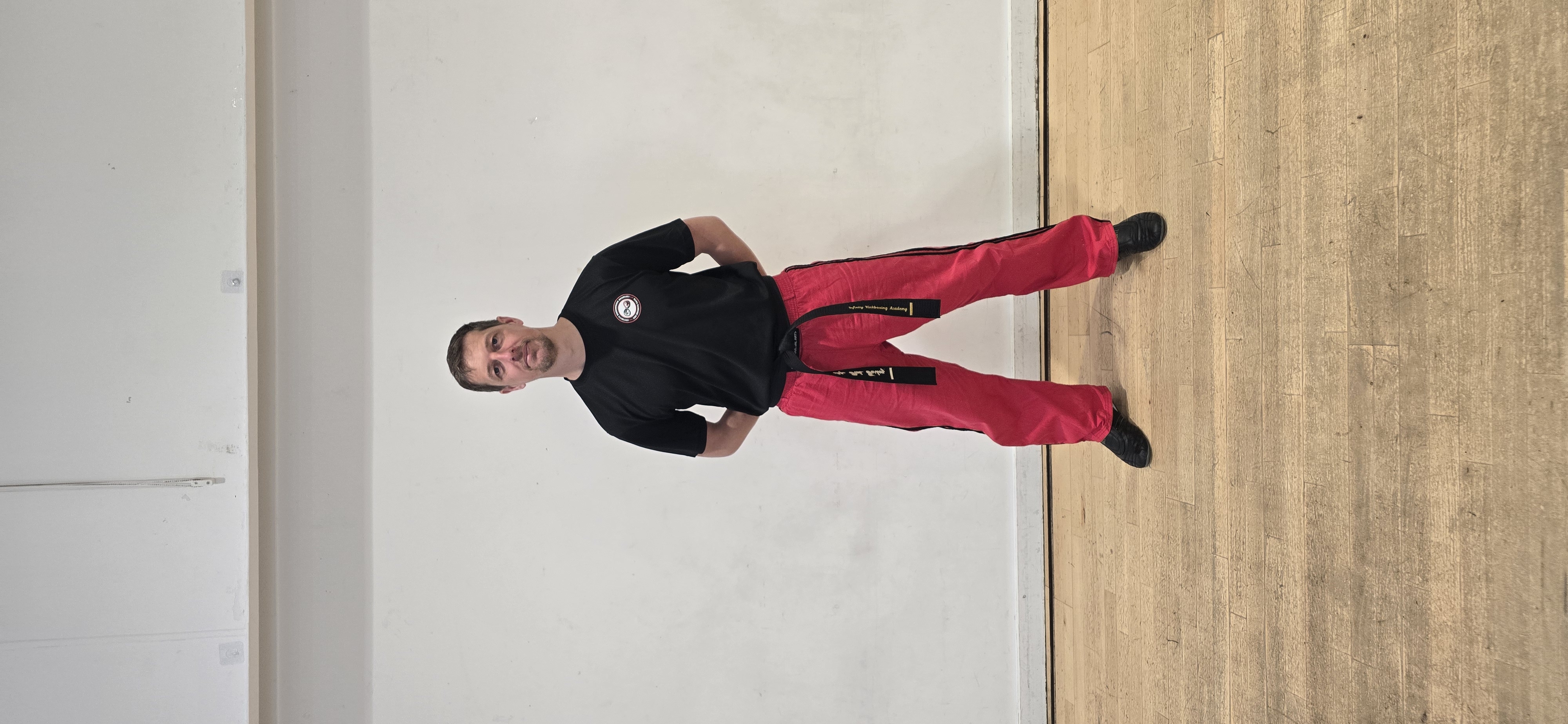 Instructor standing in formal ready position