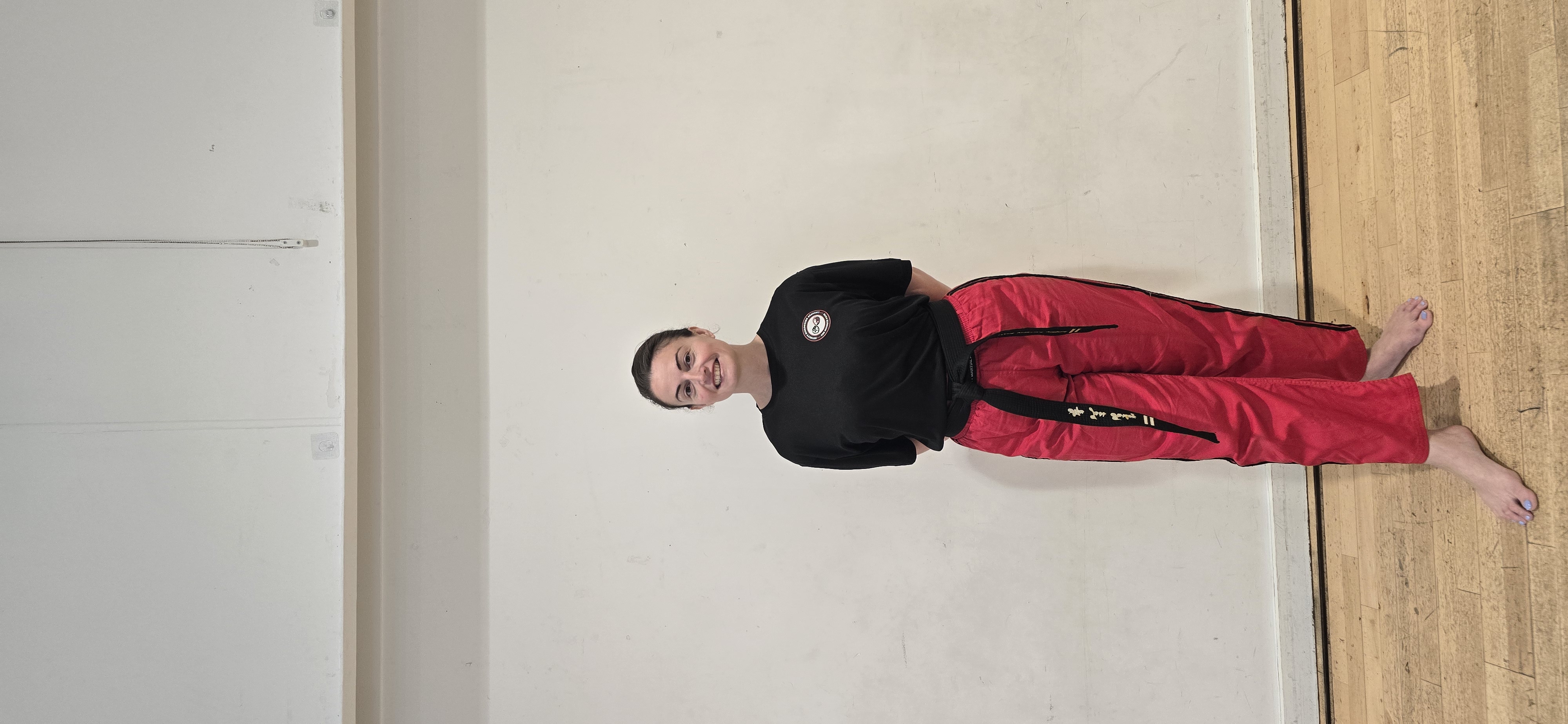 Instructor smiling in black belt uniform