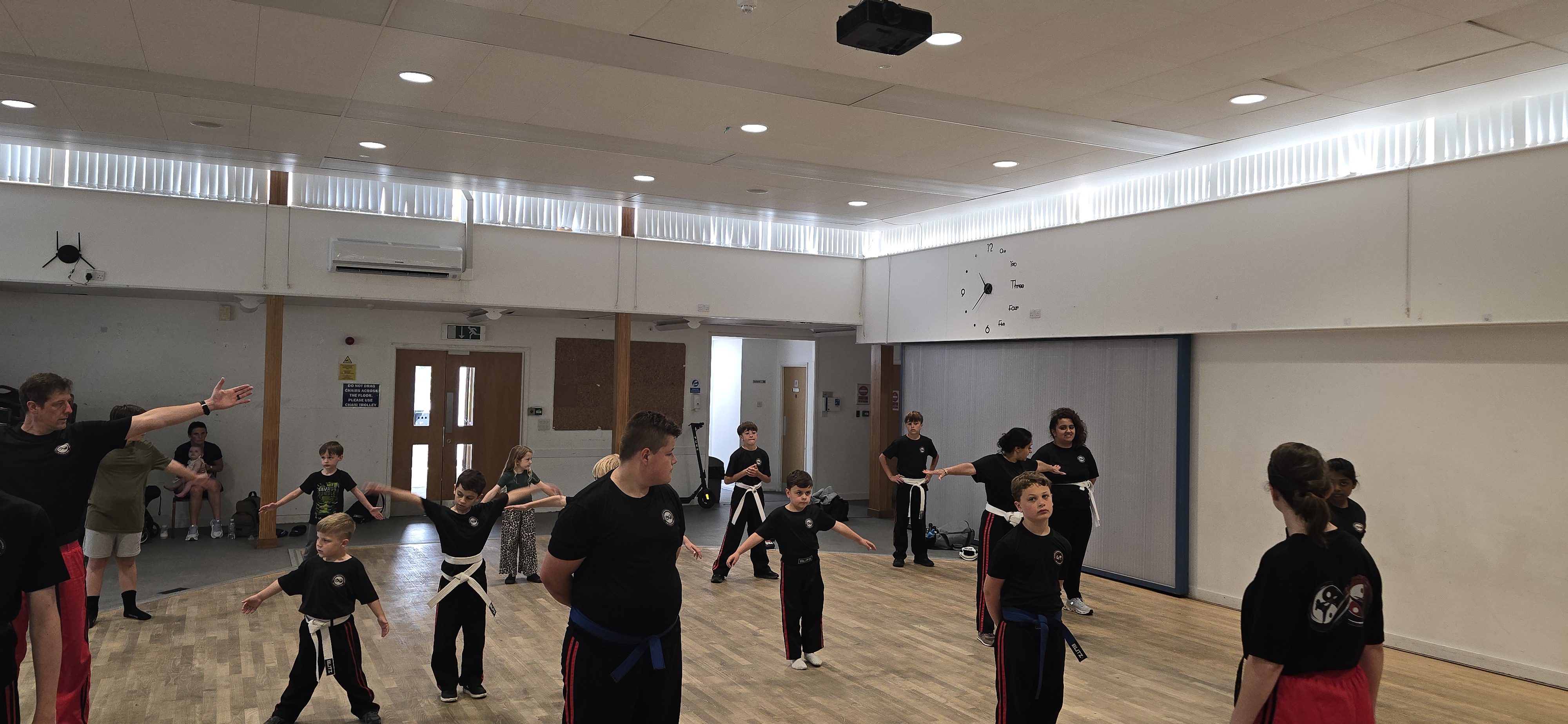 Students stretching in a circle before class