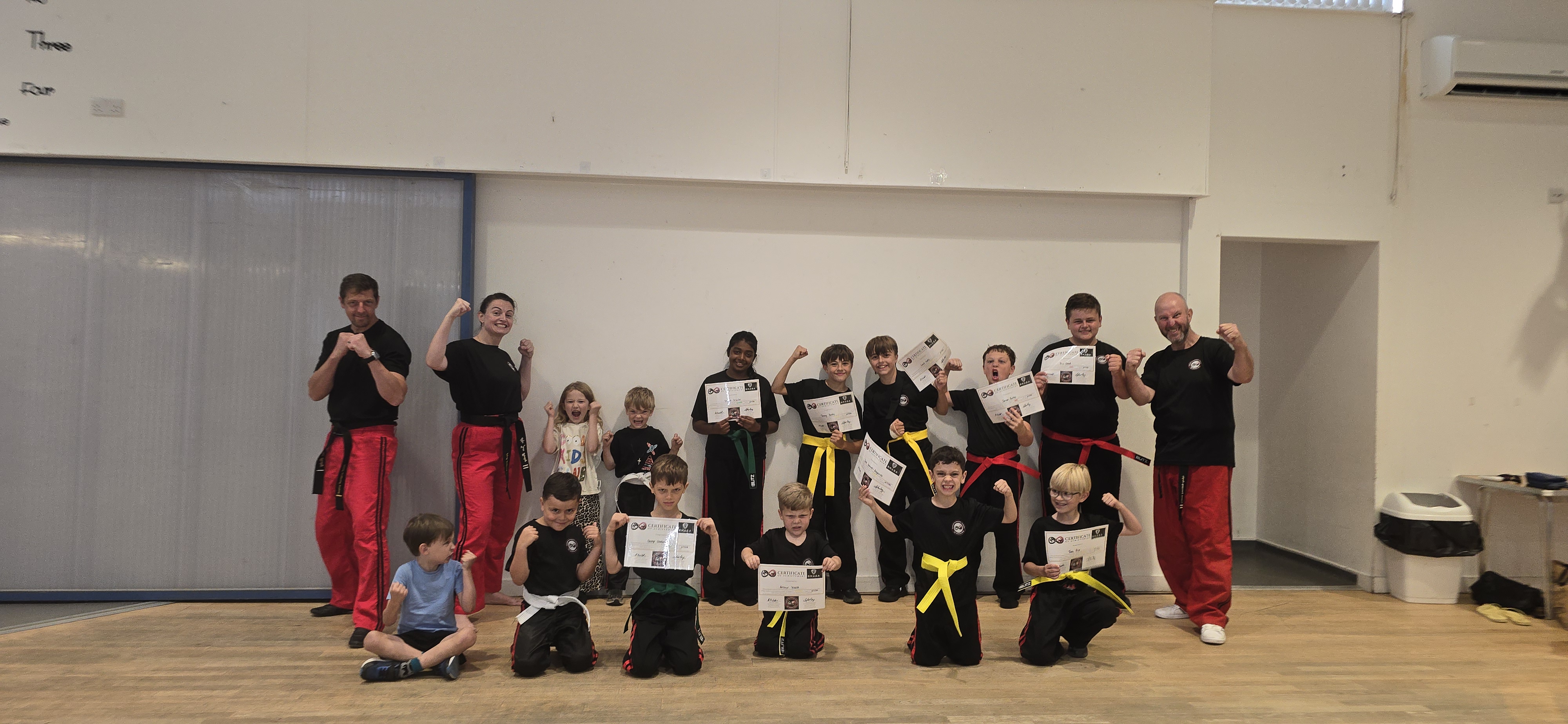Students celebrating with grading certificates
